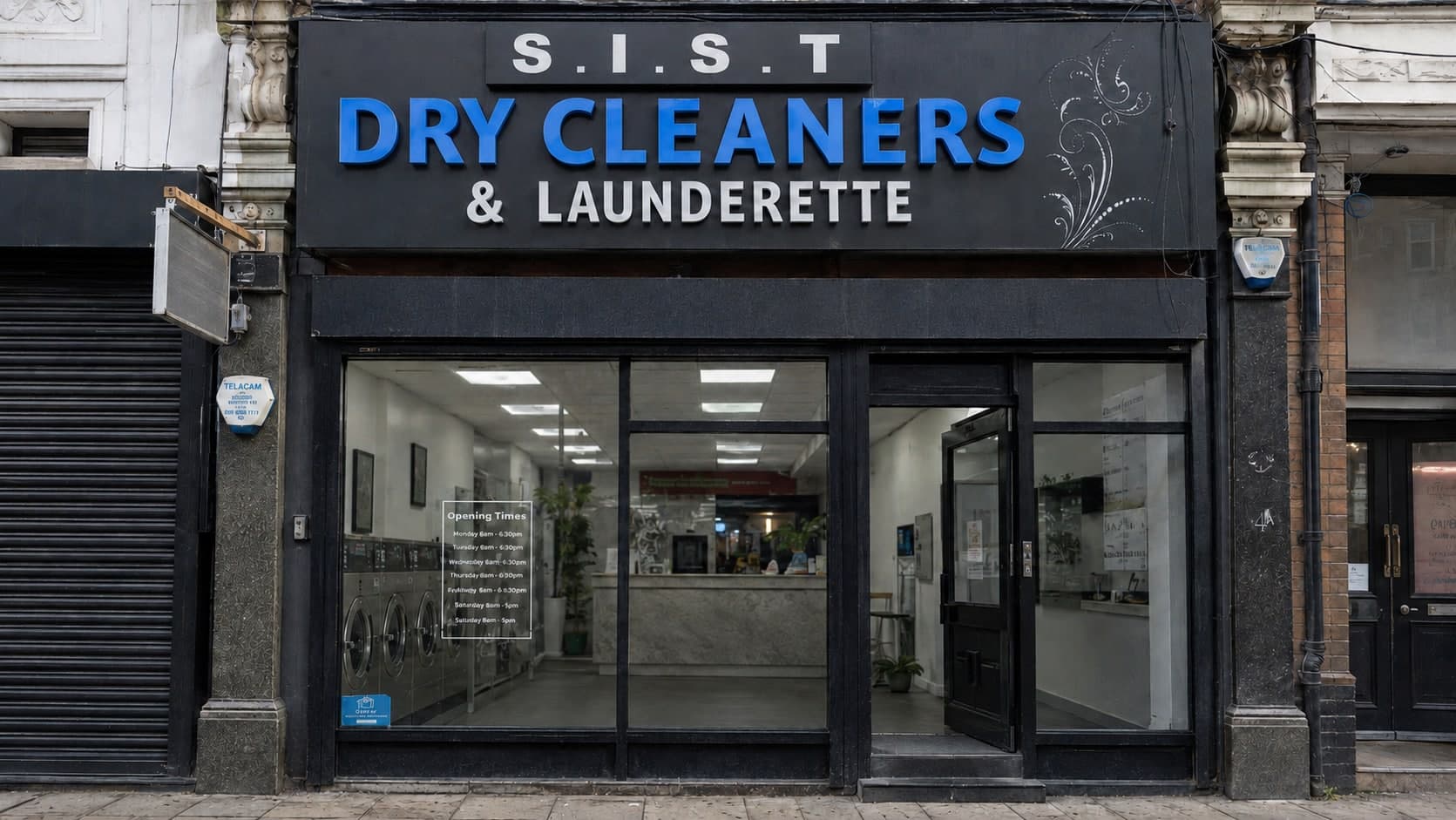 The SAV & SONS LTD shopfront on Acre Lane, with the launderette machines visible through the window