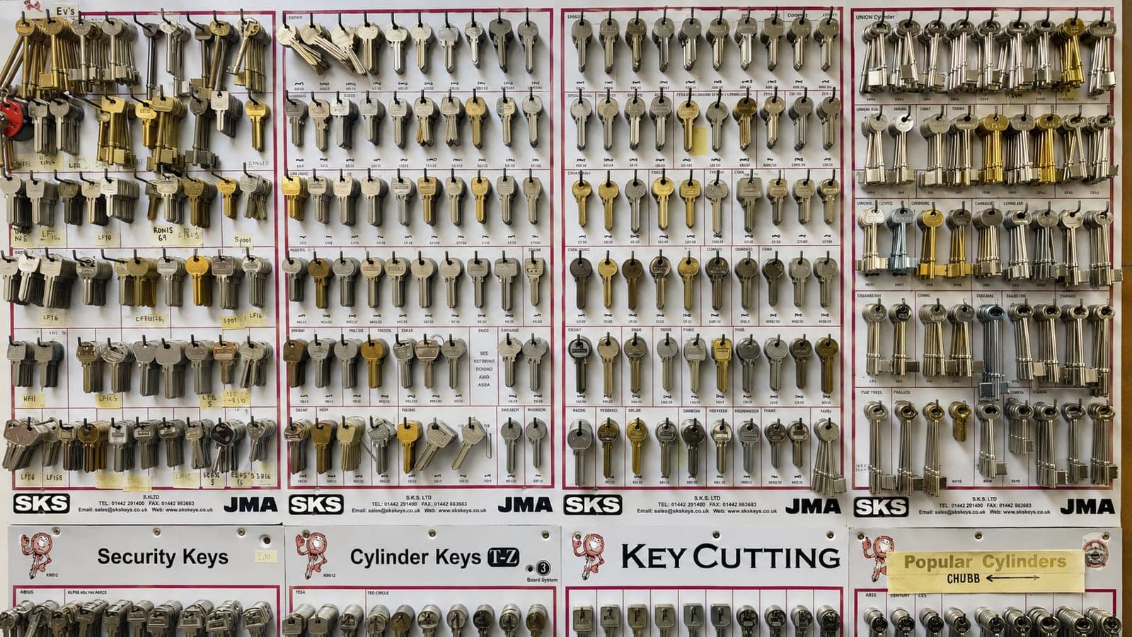 A wall display of key blanks organised by type, ready for cutting